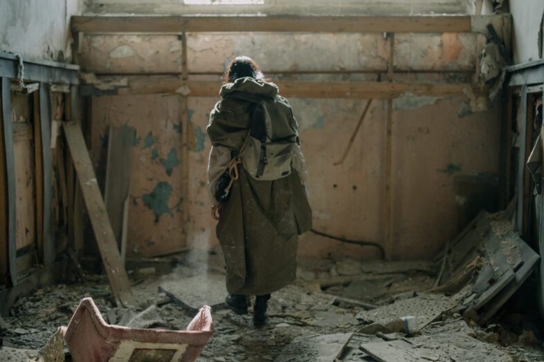 Who are preppers, prepared person standing in a derelict building